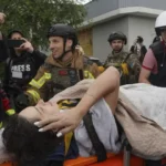 Rescuers work at a damaged apartment building after a strike in Ukraine